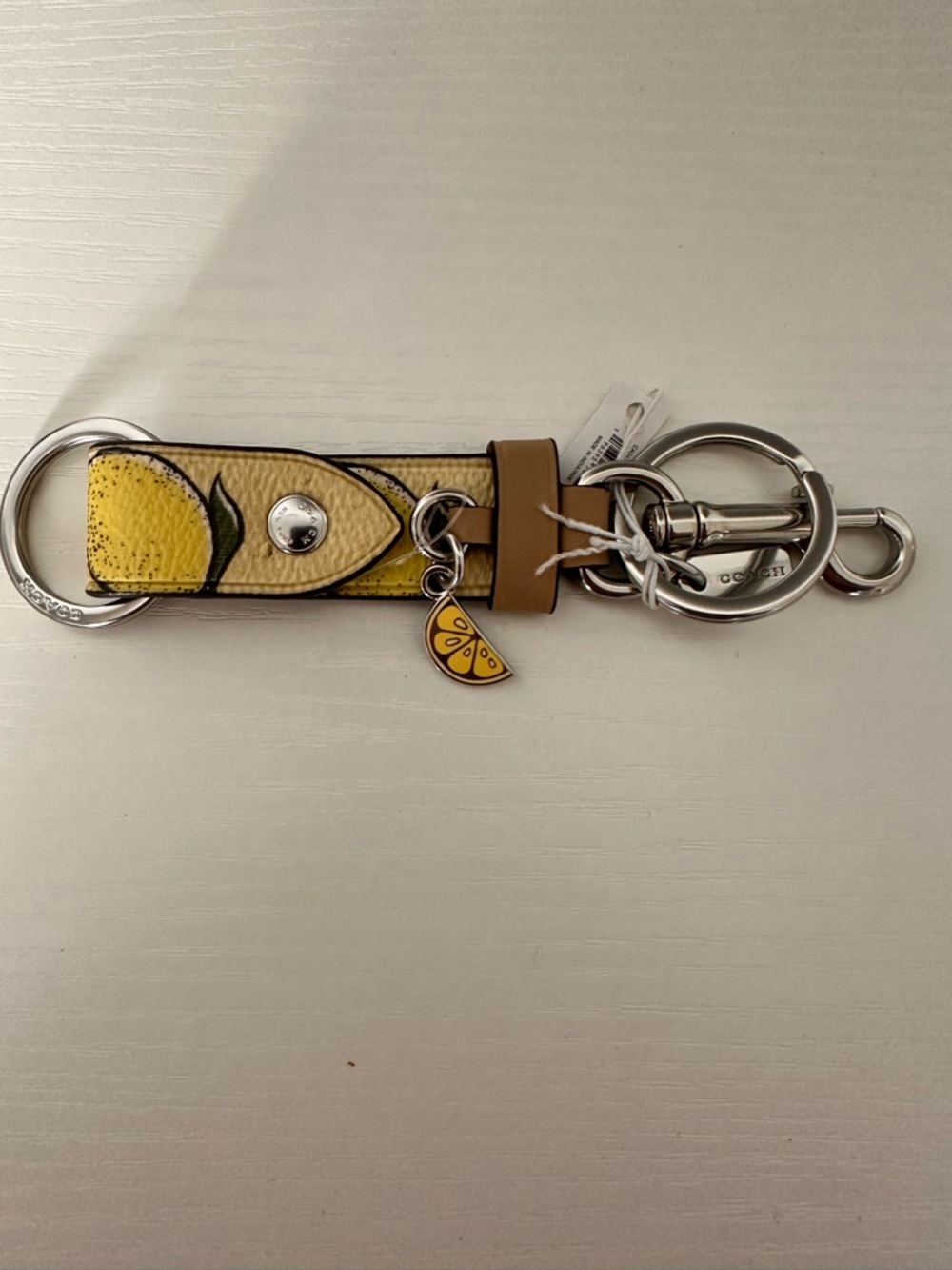NWT Coach CAO47 Trigger Snap Bag Charm With Lemon Print — Silver/Multi